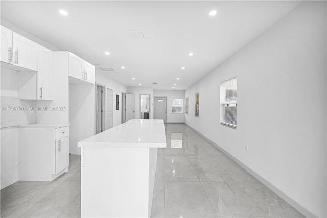 interior space featuring a center island and white cabinets