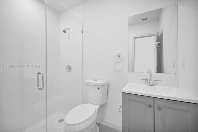 bathroom featuring vanity, toilet, and a shower with shower door