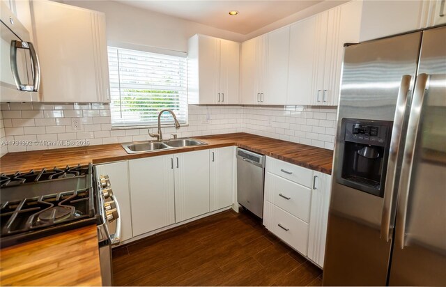 2035 NE 123rd St, North Miami, FL 33181 - kitchen with butcher block counters, appliances with stainless steel finishes, a sink, tasteful backsplash, and recessed lighting