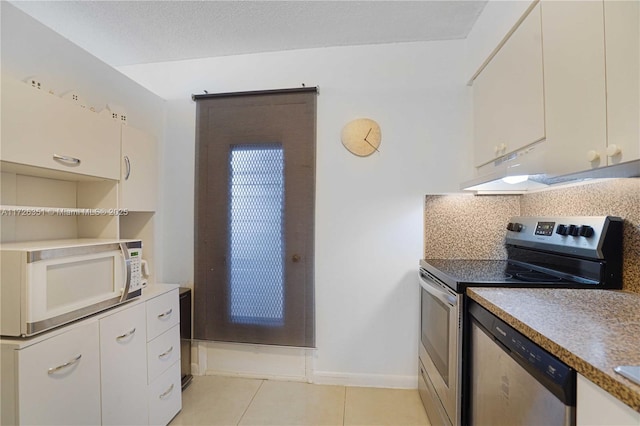 kitchen with tasteful backsplash, white cabinetry, stainless steel appliances, and light tile patterned floors