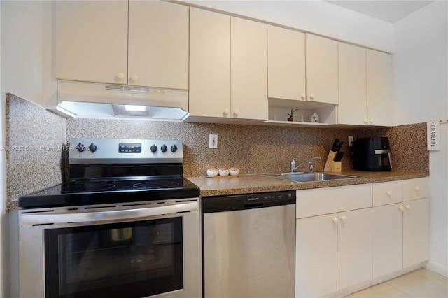 kitchen with tasteful backsplash, appliances with stainless steel finishes, sink, and light tile patterned floors