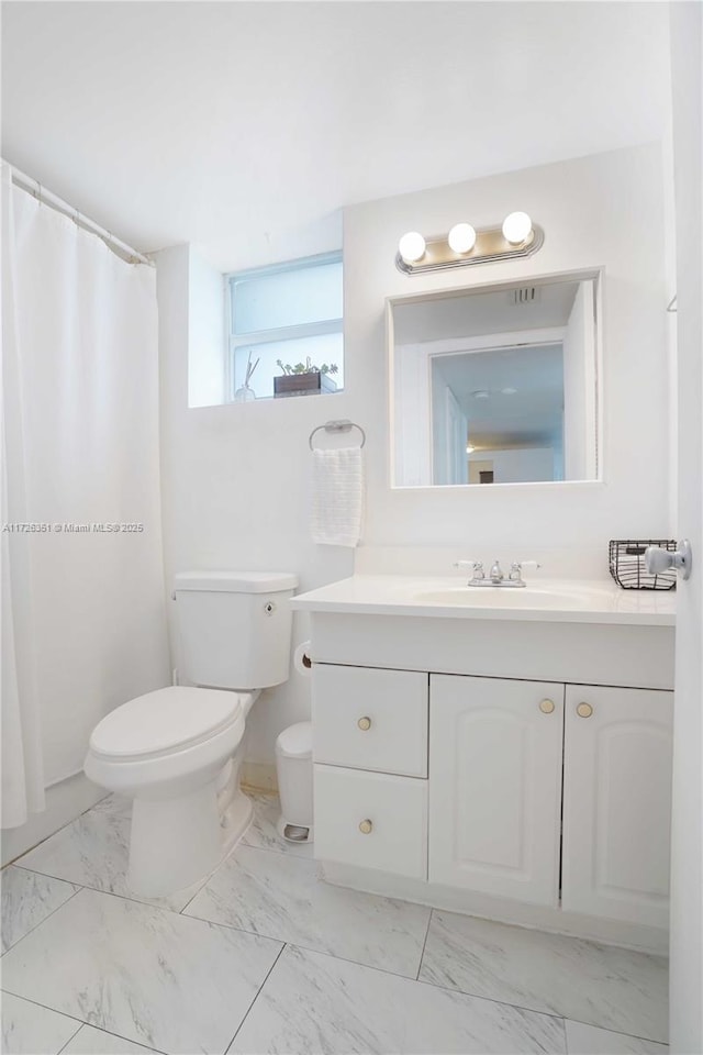 bathroom featuring vanity and toilet