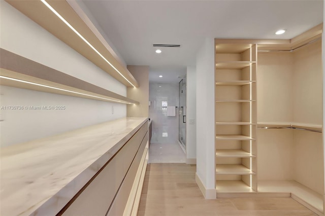 walk in closet featuring light hardwood / wood-style floors