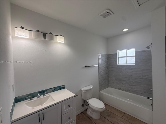 full bathroom with tiled shower / bath, vanity, toilet, and tile patterned flooring