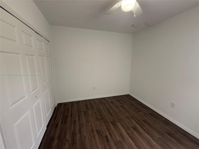 unfurnished bedroom featuring dark hardwood / wood-style flooring, a closet, and ceiling fan