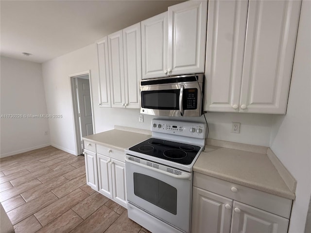 kitchen featuring white cabinetry and white electric range