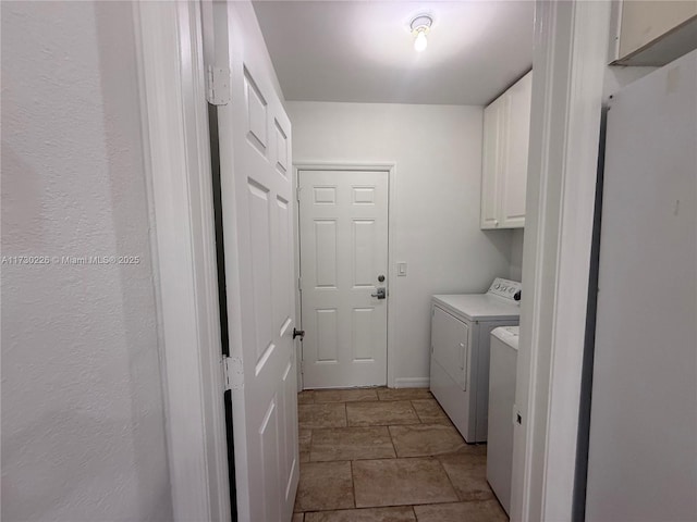 laundry area with washing machine and dryer and cabinets