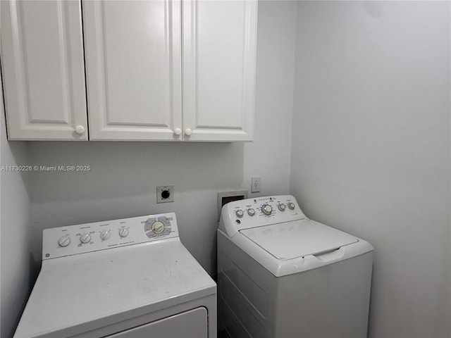 laundry room with cabinets and washing machine and dryer