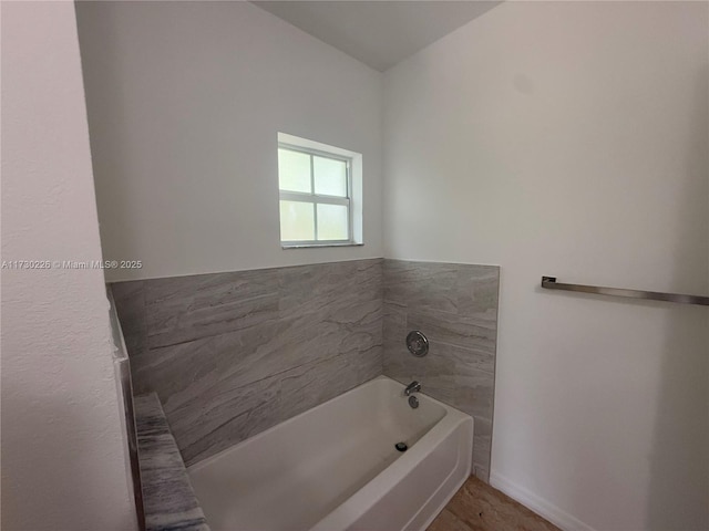 bathroom with a tub to relax in