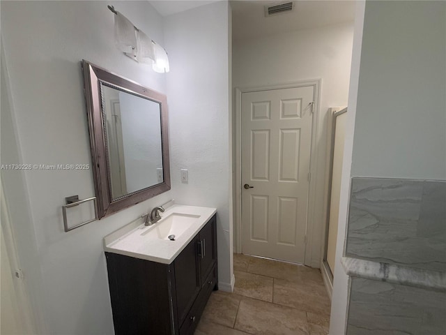 bathroom with walk in shower, tile patterned floors, and vanity