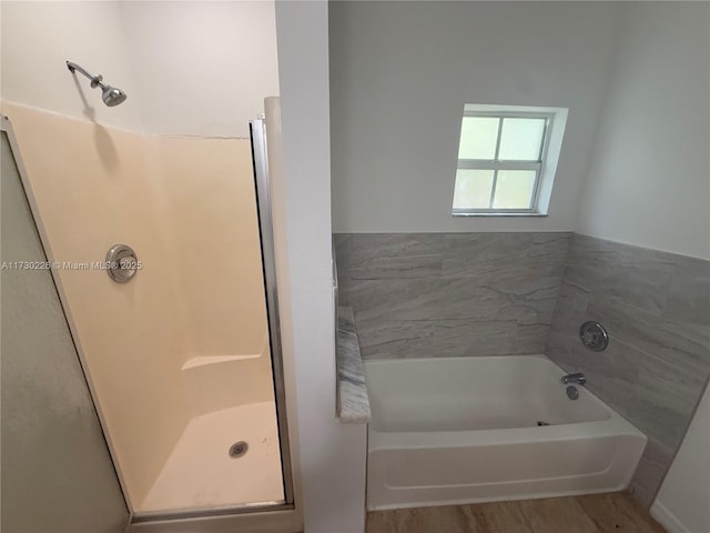 bathroom featuring wood-type flooring and separate shower and tub