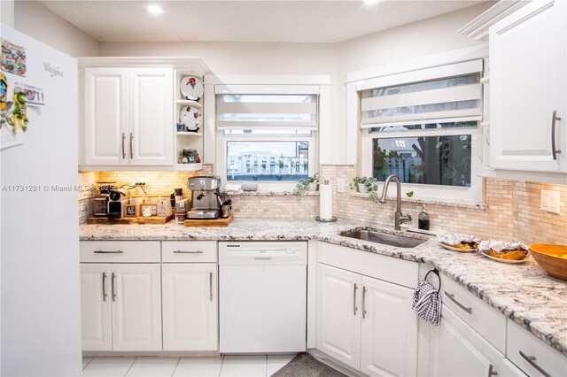 kitchen featuring white dishwasher and white cabinets