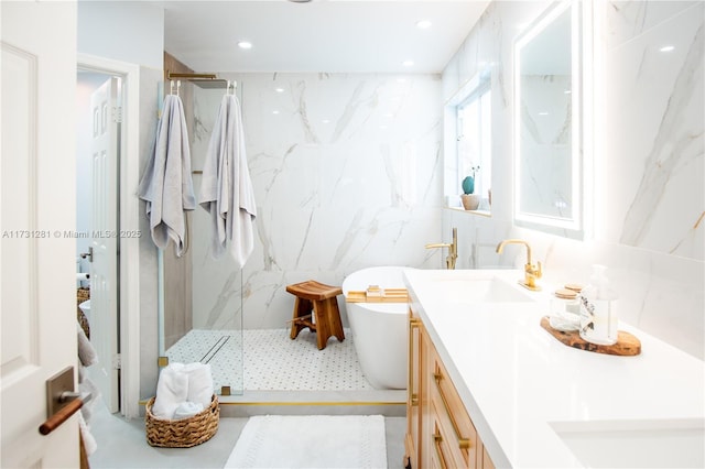 bathroom featuring vanity, plus walk in shower, and tile walls