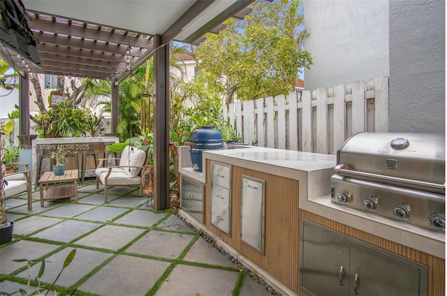 view of patio / terrace with a pergola, grilling area, and exterior kitchen