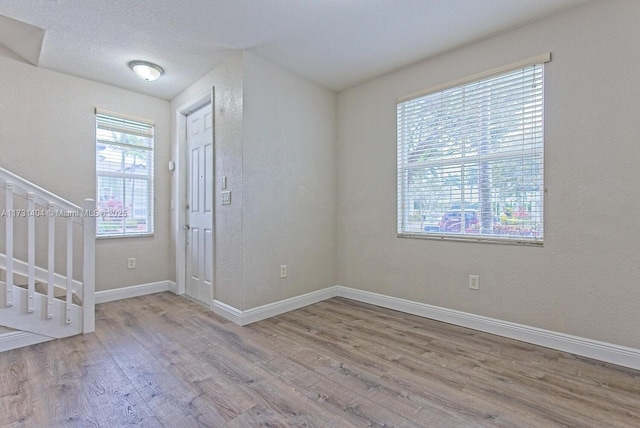 foyer with plenty of natural light and light hardwood / wood-style flooring