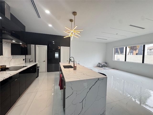 kitchen with sink, a chandelier, pendant lighting, a large island, and black appliances