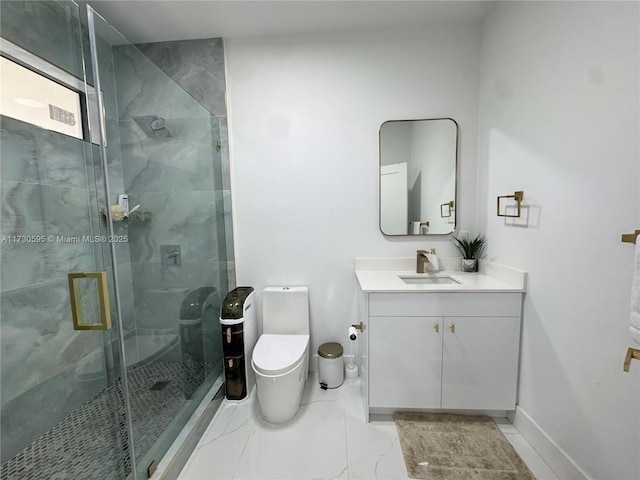 bathroom with vanity, a shower with door, and toilet