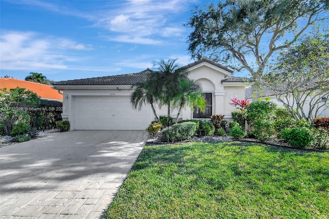 view of front of property featuring a garage and a front lawn