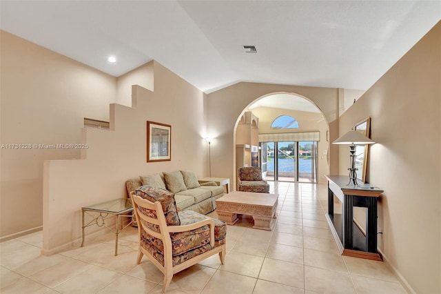 12915 Coral Lakes Dr, Boynton Beach, FL 33437 - living area with arched walkways, light tile patterned floors, high vaulted ceiling, and baseboards
