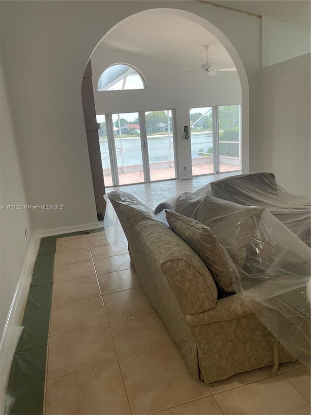 12915 Coral Lakes Dr, Boynton Beach, FL 33437 - living area featuring arched walkways, light tile patterned floors, and a ceiling fan