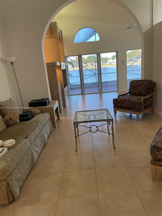12915 Coral Lakes Dr, Boynton Beach, FL 33437 - living room featuring healthy amount of natural light, arched walkways, a ceiling fan, and light tile patterned floors