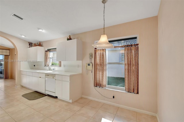12915 Coral Lakes Dr, Boynton Beach, FL 33437 - kitchen featuring dishwasher, a sink, arched walkways, light countertops, and light tile patterned floors