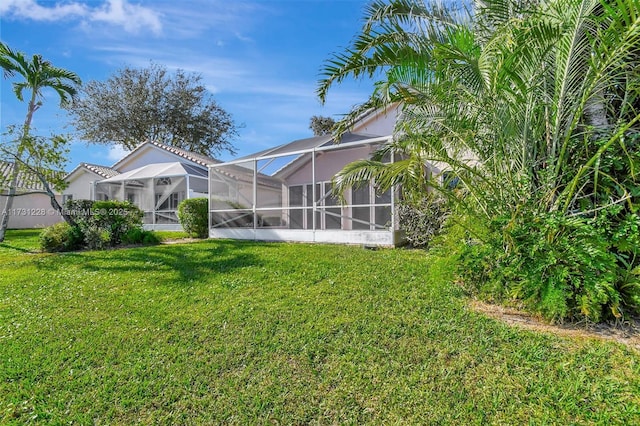 12915 Coral Lakes Dr, Boynton Beach, FL 33437 - rear view of property with a lawn and glass enclosure