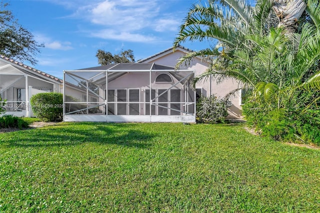 12915 Coral Lakes Dr, Boynton Beach, FL 33437 - back of property with a lawn, a lanai, and stucco siding