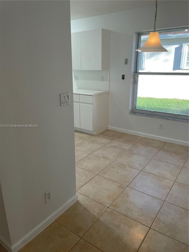 12915 Coral Lakes Dr, Boynton Beach, FL 33437 - unfurnished dining area featuring light tile patterned floors and baseboards