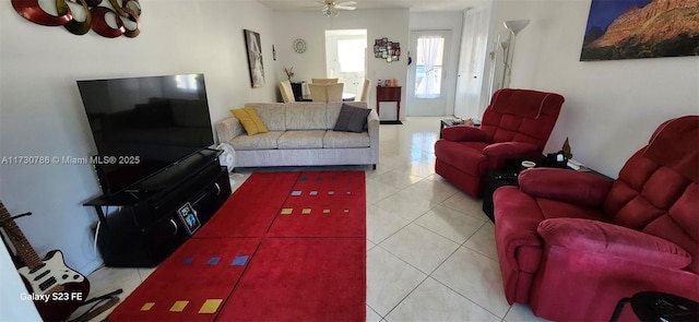 living room with light tile patterned floors and ceiling fan