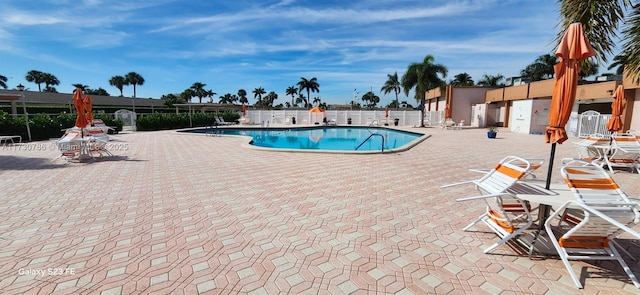 view of swimming pool featuring a patio area