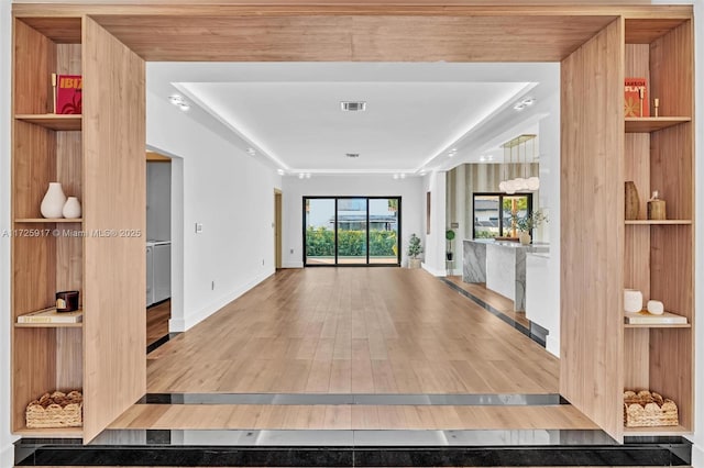 interior space featuring wood finished floors, visible vents, and baseboards