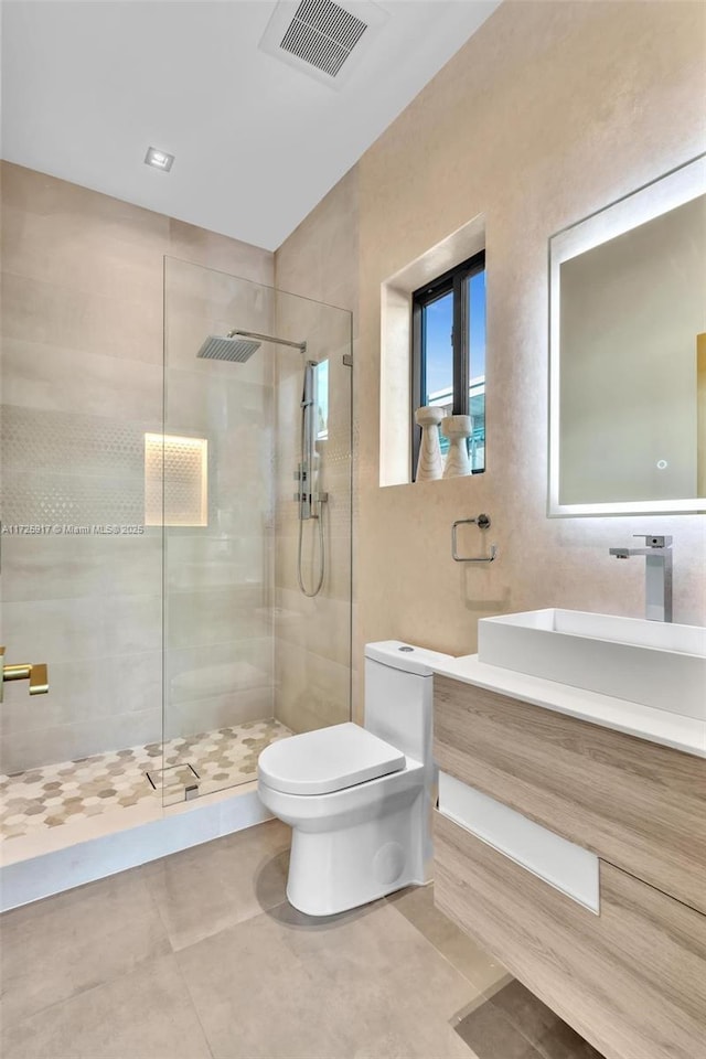 bathroom featuring a walk in shower, tile patterned flooring, toilet, vanity, and visible vents