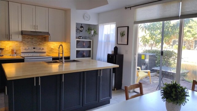 kitchen featuring white range with electric stovetop, wooden counters, white cabinets, a kitchen island with sink, and black fridge with ice dispenser