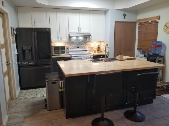 clothes washing area with cabinets and separate washer and dryer