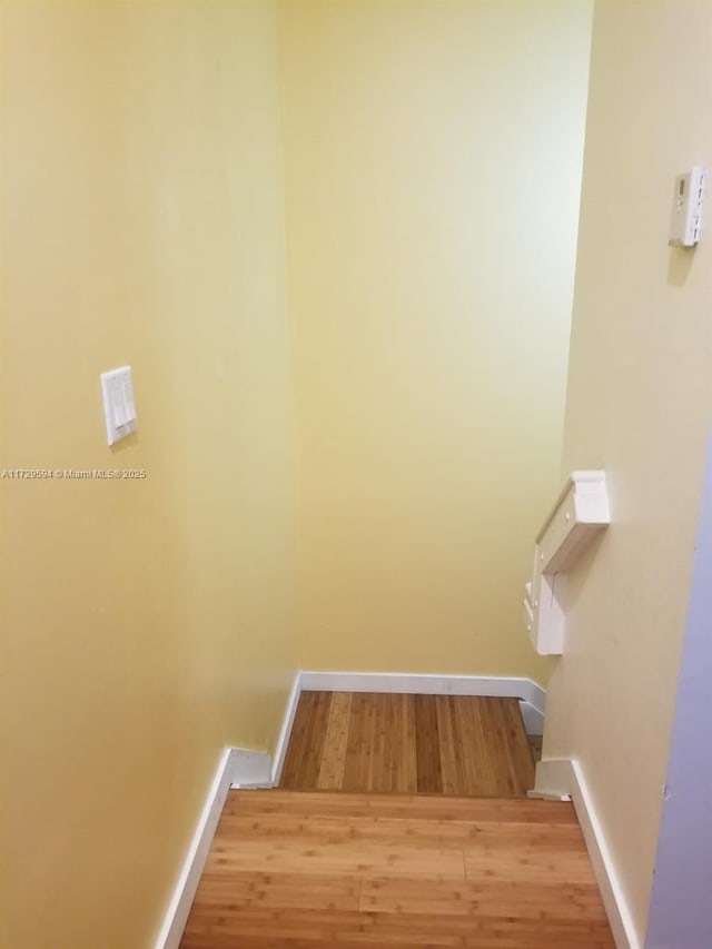 stairway with hardwood / wood-style flooring