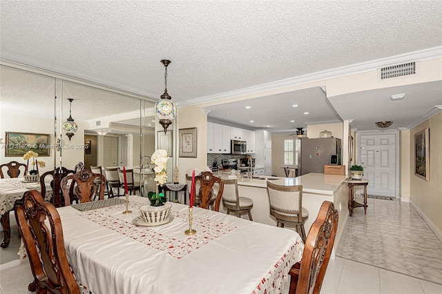 dining area with crown molding and a textured ceiling