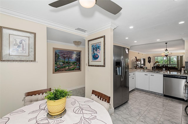 kitchen with stainless steel appliances, white cabinetry, sink, and ornamental molding