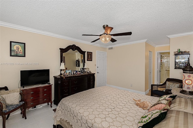 bedroom featuring ensuite bathroom, light tile patterned floors, ceiling fan, crown molding, and a textured ceiling