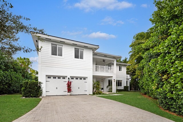 view of front of house featuring a balcony and a garage