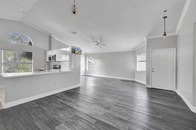 unfurnished living room featuring ornamental molding, sink, dark wood-type flooring, and ceiling fan