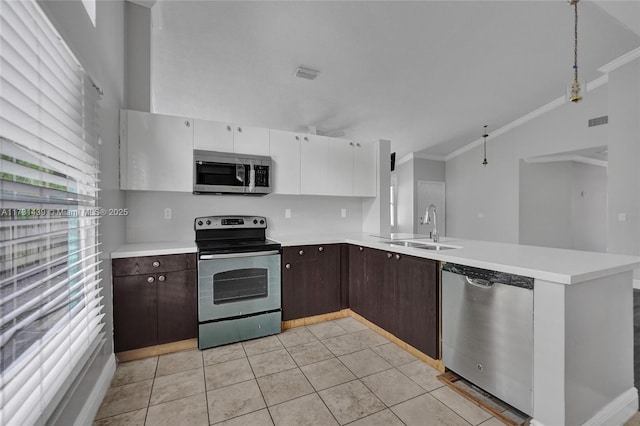 kitchen with dark brown cabinetry, sink, white cabinetry, light tile patterned floors, and stainless steel appliances