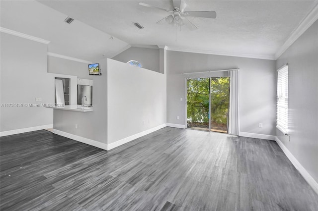 interior space with lofted ceiling, dark hardwood / wood-style flooring, ornamental molding, and ceiling fan