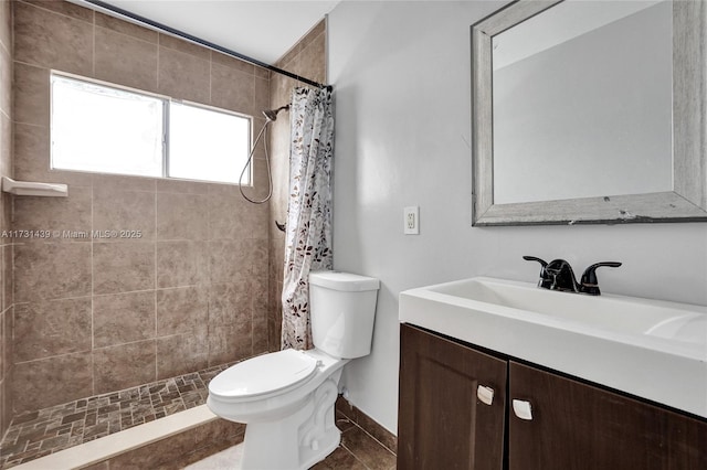 bathroom with vanity, toilet, curtained shower, and tile patterned flooring