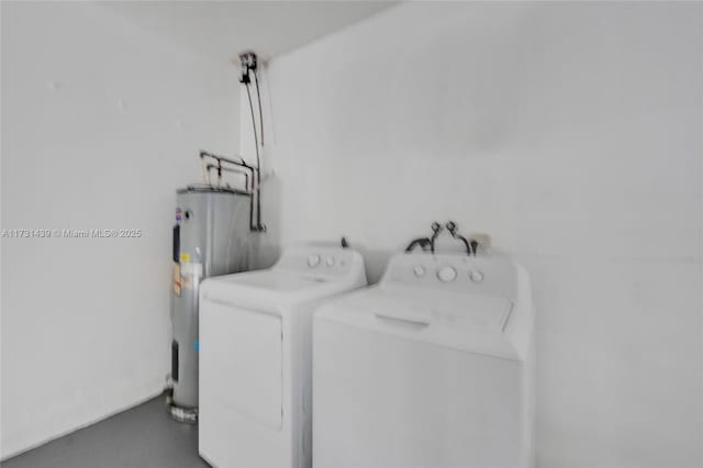 clothes washing area with washing machine and clothes dryer and electric water heater