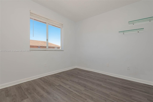 spare room with dark hardwood / wood-style flooring