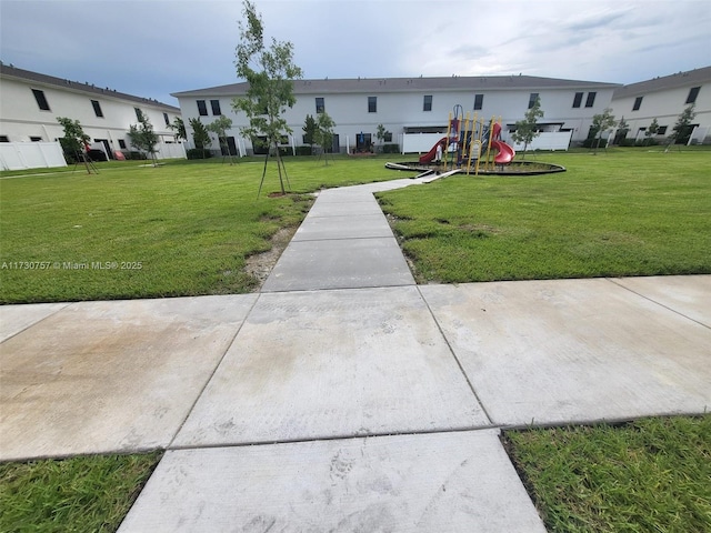 exterior space with a playground and a yard