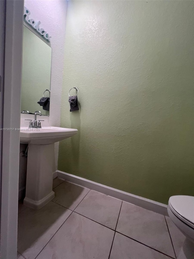 bathroom featuring tile patterned flooring, sink, and toilet