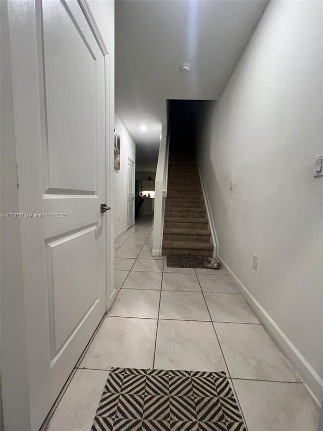 hall featuring light tile patterned flooring