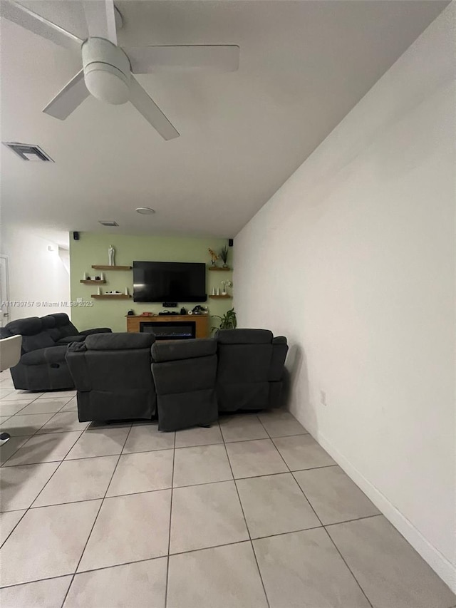 tiled living room featuring lofted ceiling and ceiling fan